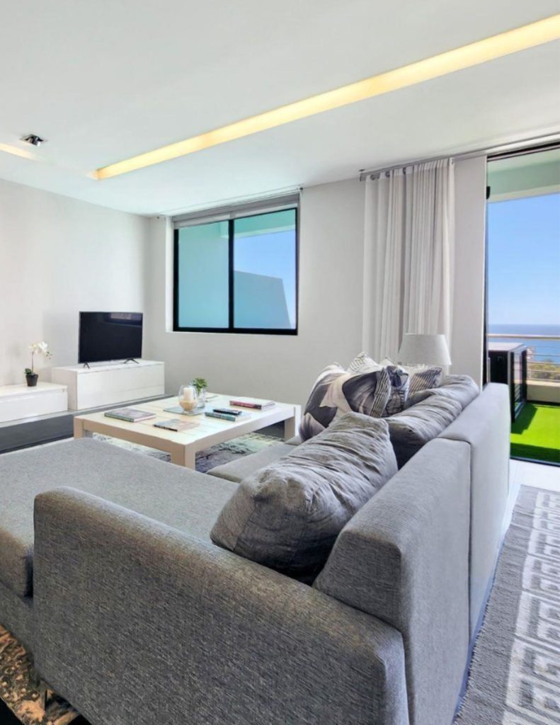 Modern open-plan apartment lounge with sea views in Brackenfell, Cape Town